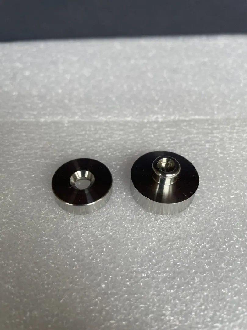 A pair of metal washers sitting on top of a table.