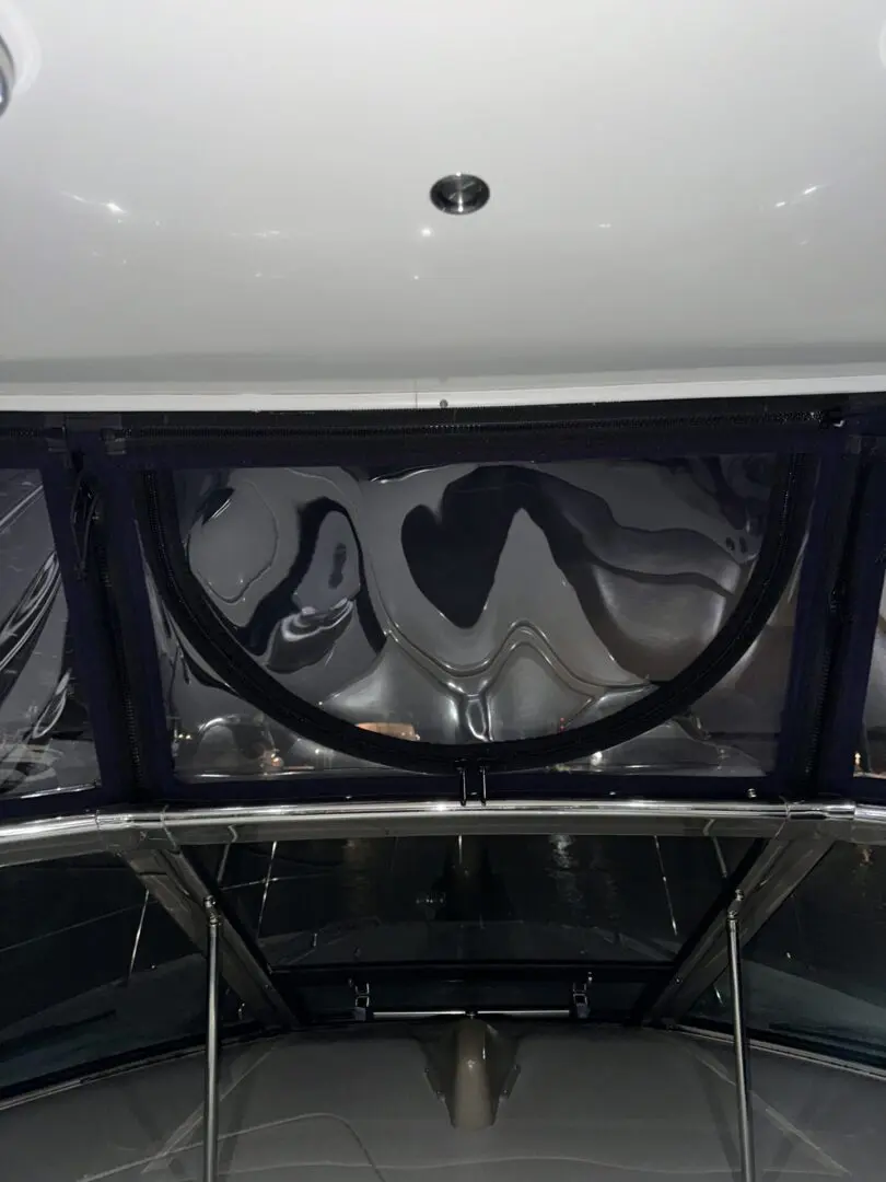 A view of the inside of a boat with some covers on it.